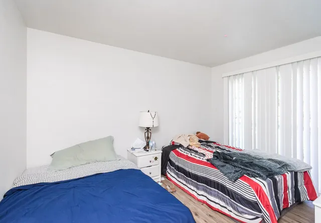 a bedroom with a bed and a window