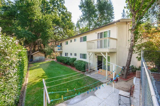 a view of a house with backyard and sitting area