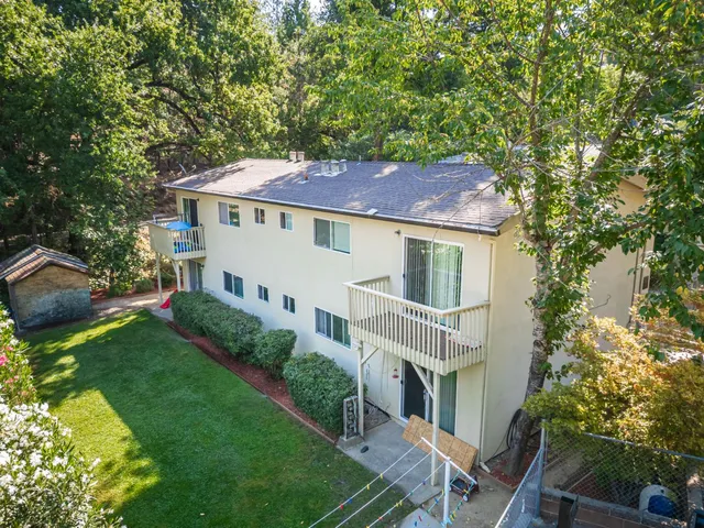 a house with green field in front of it
