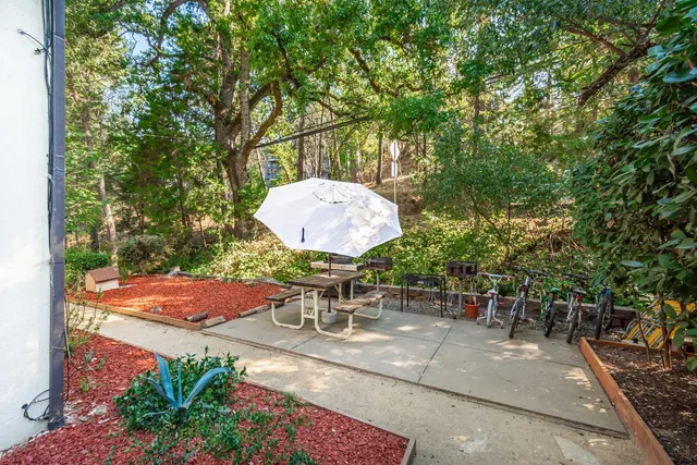 a backyard of a house with table and chairs