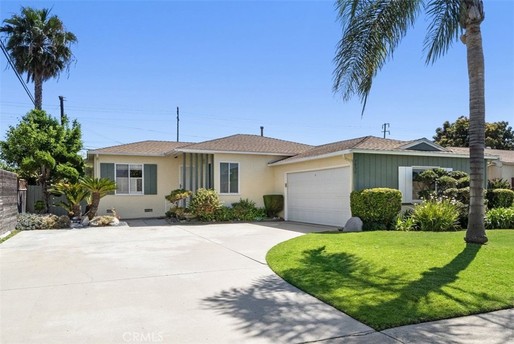 7852 Darwin Avenue Midway City, CA 92683 - Photo 1 of 1 a front view of a house with a yard and potted plants