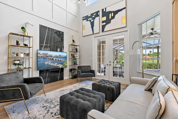 a living room with furniture a flat screen tv and a fireplace