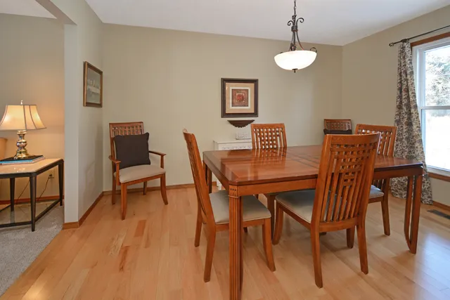 a view of a hallway with wooden floor and stairs
