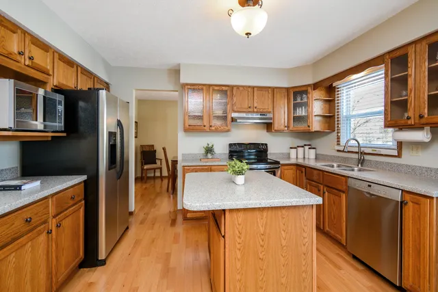 a kitchen with stainless steel appliances granite countertop a sink stove and refrigerator