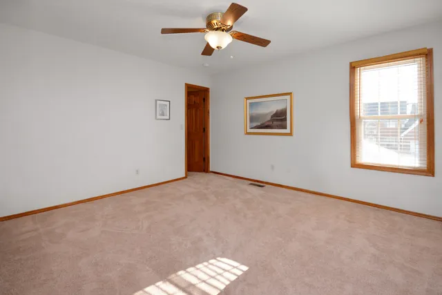 a view of a dining room and livingroom with furniture wooden floor a chandelier