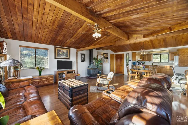 a bedroom with furniture and large windows