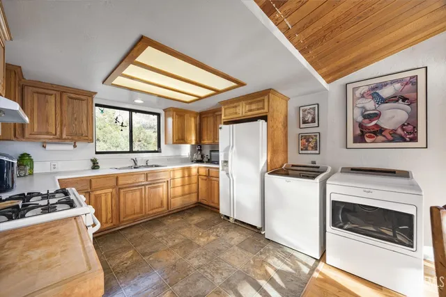 a kitchen with a stove a sink and a refrigerator