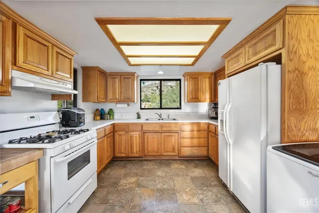 a kitchen with stainless steel appliances a stove sink and refrigerator
