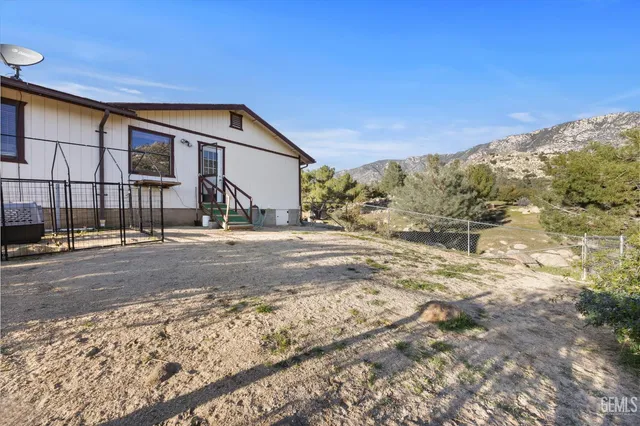 a view of a house with a snow on the road
