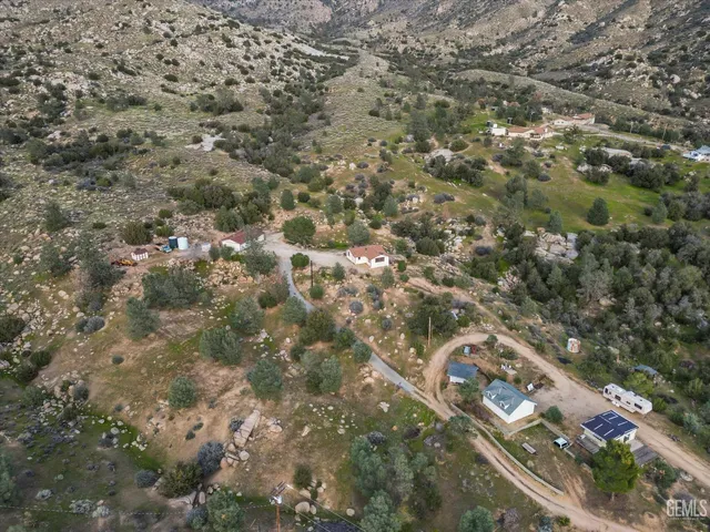 a view of a forest with mountains in the background