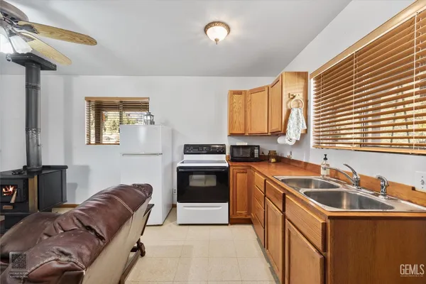 a kitchen with stainless steel appliances granite countertop a stove a sink and a refrigerator