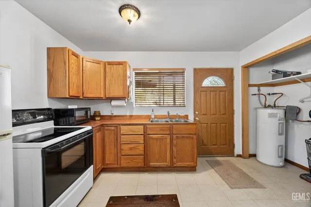 a bedroom with a bed and a dresser with wooden floor