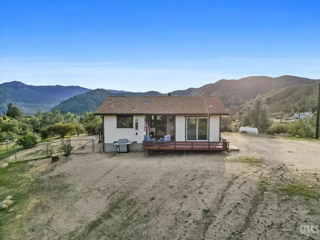 a view of a house with a mountain yard