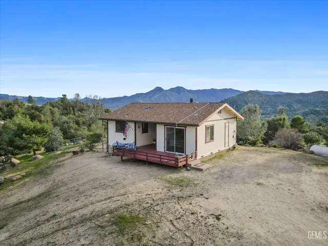 a view of a house with a yard and sitting area