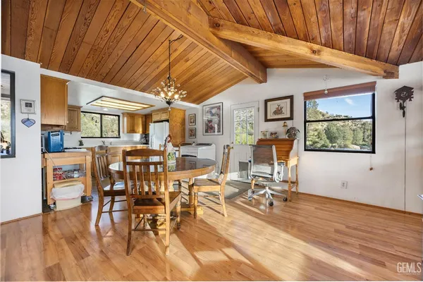 a view of a dining hall with furniture and wooden floor