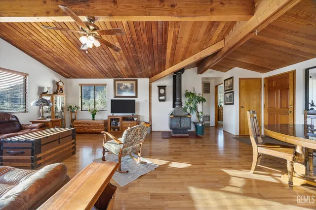 a living room with furniture a wooden floor and next to a window