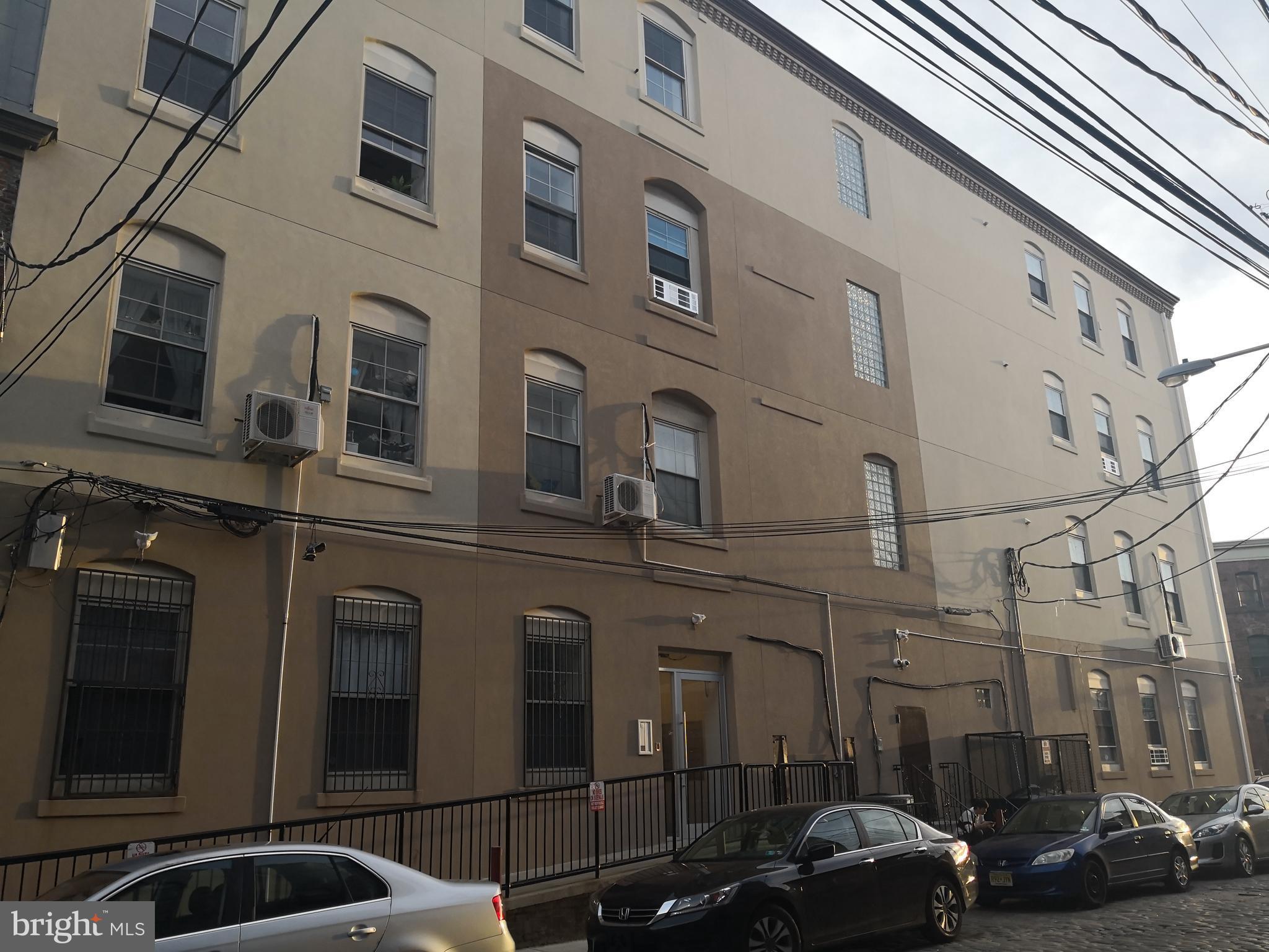 1020 Hamilton Street, Unit 4 Philadelphia, PA 19123 - Photo 2 of 19 a couple of cars parked in front of a building