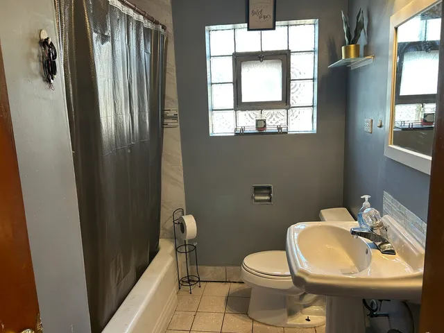 a kitchen that has a sink stainless steel appliances a window and a counter top space