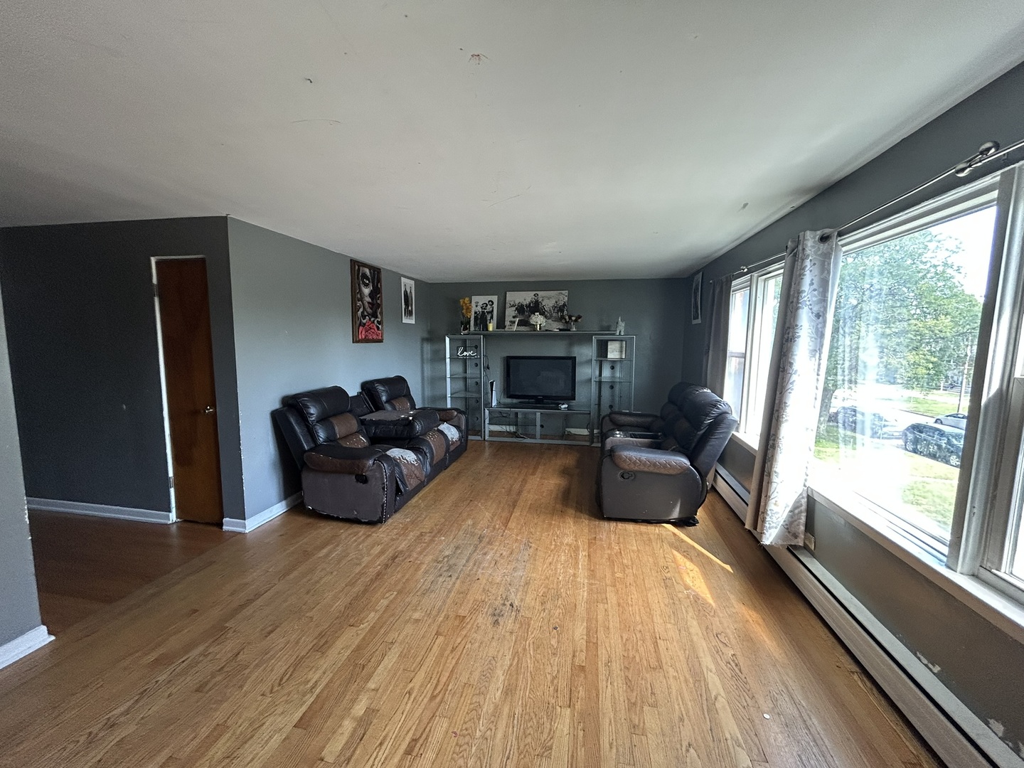 1724 North 19th Avenue Melrose Park, IL 60160 - Photo 8 of 16 a living room with furniture fireplace and a large window