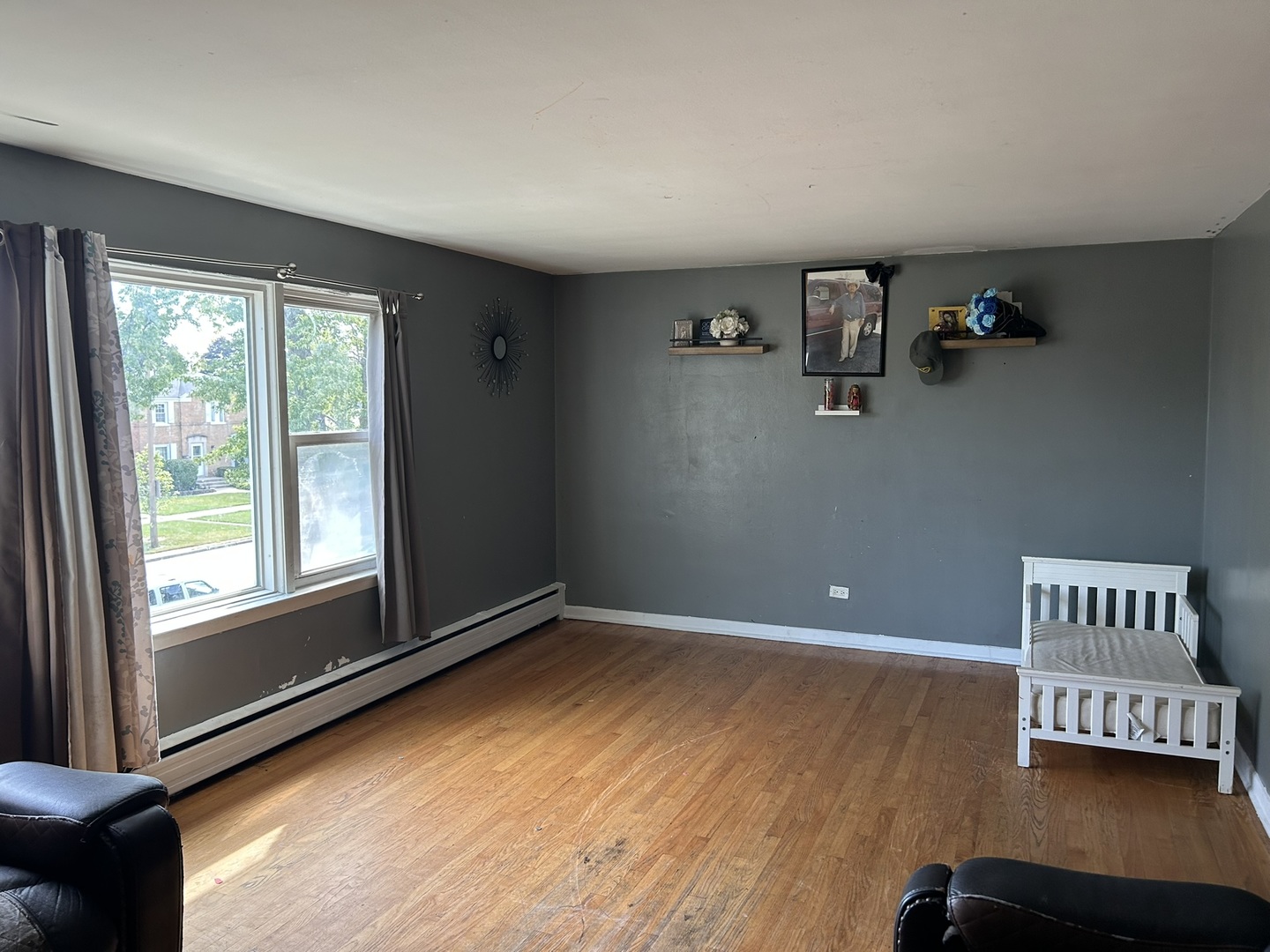 1724 North 19th Avenue Melrose Park, IL 60160 - Photo 9 of 16 a view of an empty room with a window and wooden floor