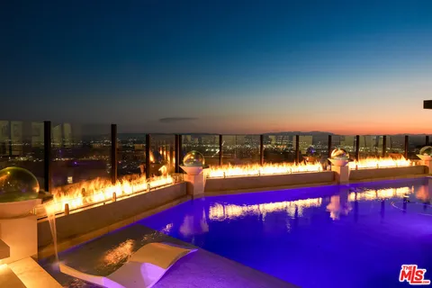 a living room with furniture a flat screen tv and a floor to ceiling window
