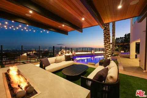 a living room with furniture a flat screen tv and a large window