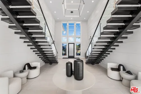 a large kitchen with stainless steel appliances a stove and a sink