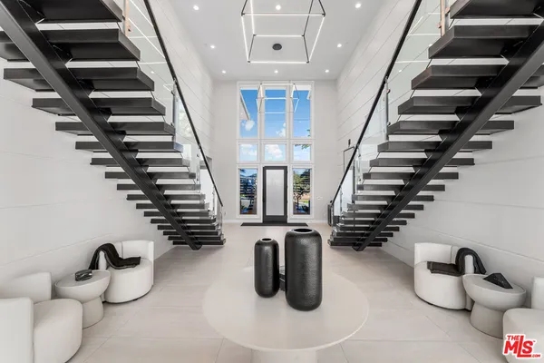 a large kitchen with stainless steel appliances a stove and a sink