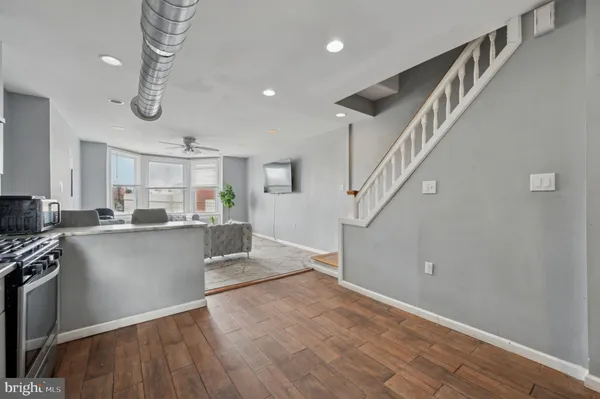 a kitchen with a refrigerator stove and wooden cabinets