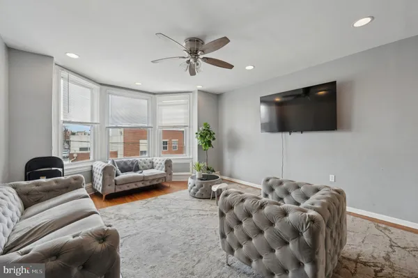 a living room with furniture and kitchen view