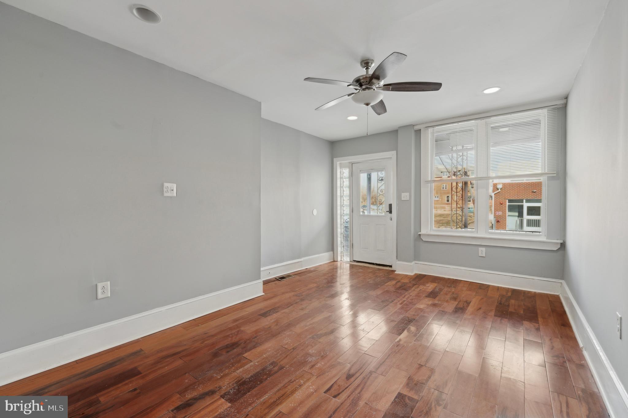 3236 West Berks Street Philadelphia, PA 19121 - Photo 6 of 35 a view of an empty room with wooden floor and a window