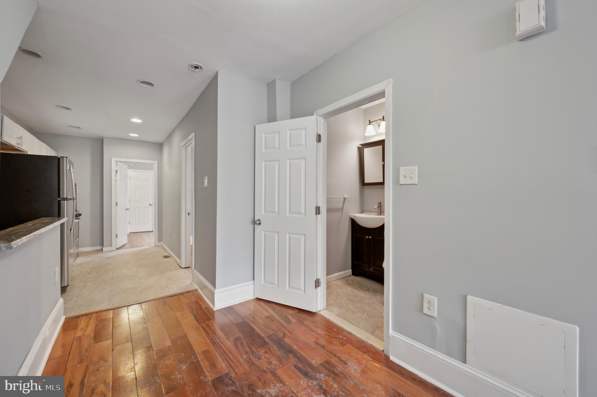 3236 West Berks Street Philadelphia, PA 19121 - Photo 7 of 35 a view of a hallway with wooden floor and a bathroom
