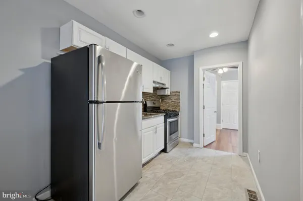 a kitchen with a refrigerator and a stove