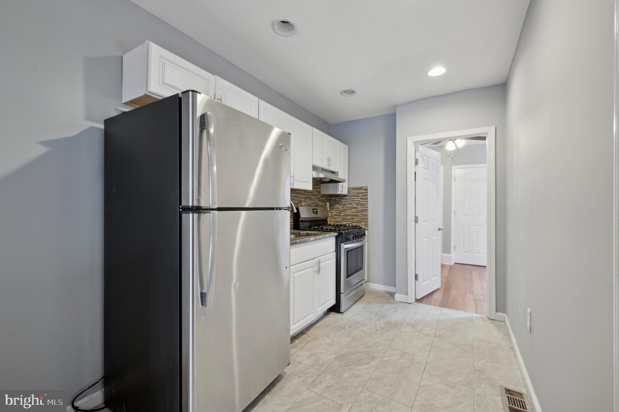 3236 West Berks Street Philadelphia, PA 19121 - Photo 10 of 35 a kitchen with a refrigerator and a stove