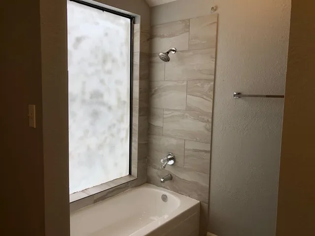 a bathroom with a granite countertop sink a toilet and shower