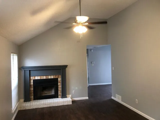 a room with a fireplace and wooden floor