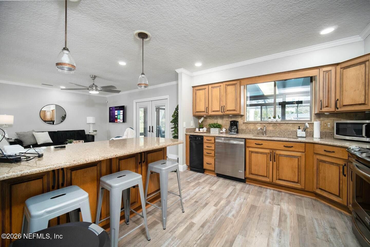 11613 Lake Ride Drive Jacksonville, FL 32223 - Photo 20 of 42 a large white kitchen with lots of counter space a sink and appliances