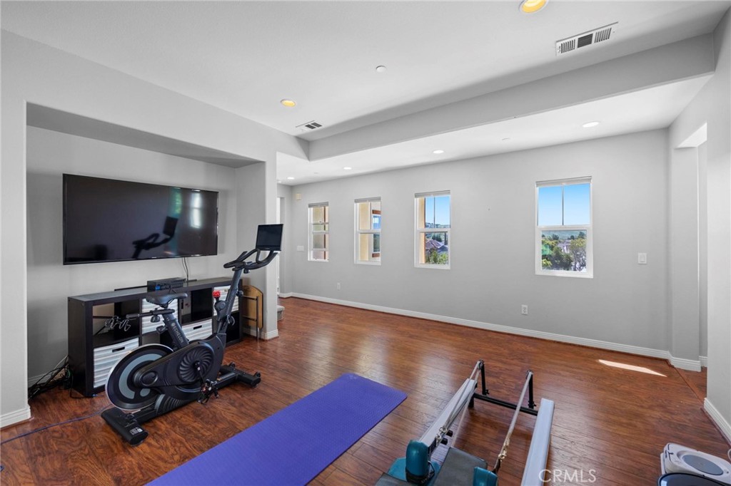 47 Bedstraw Loop Ladera Ranch, CA 92694 - Photo 24 of 44 a view of a livingroom with furniture a flat screen tv and wooden floor