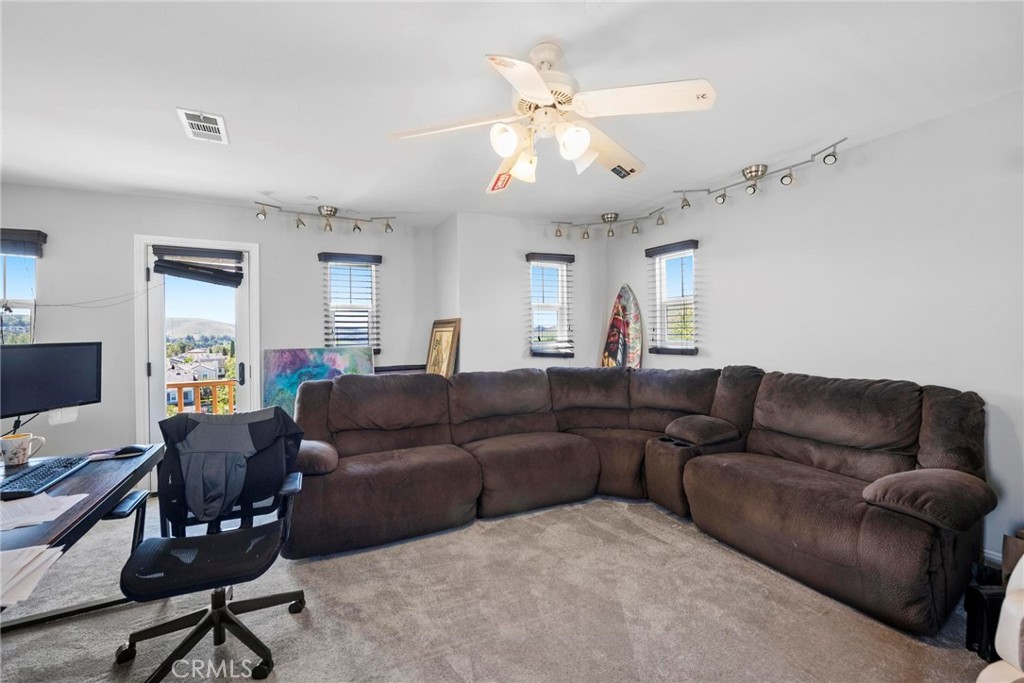 47 Bedstraw Loop Ladera Ranch, CA 92694 - Photo 29 of 44 a living room with furniture a large window and a chandelier