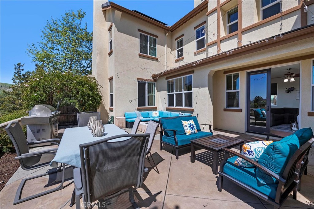 47 Bedstraw Loop Ladera Ranch, CA 92694 - Photo 34 of 44 a view of a patio with a dining table and chairs