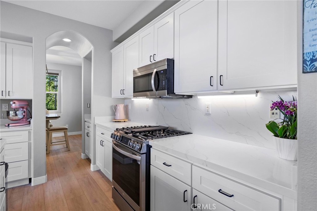 47 Bedstraw Loop Ladera Ranch, CA 92694 - Photo 8 of 44 a kitchen with stainless steel appliances white cabinets and a stove top oven