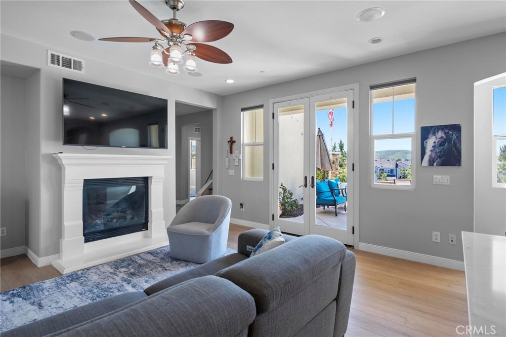 47 Bedstraw Loop Ladera Ranch, CA 92694 - Photo 10 of 44 a living room with furniture a flat screen tv and a fireplace