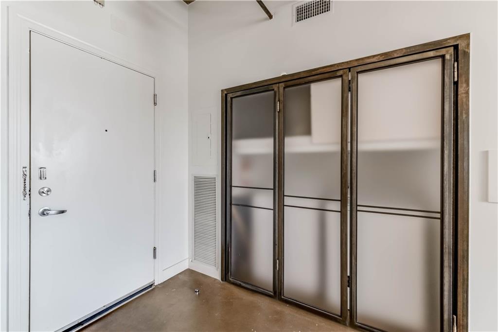 710 Colorado Street, Unit G9 Austin, TX 78701 - Photo 7 of 25 Enter into a bright space featuring unique frosted glass closet doors and polished concrete flooring.