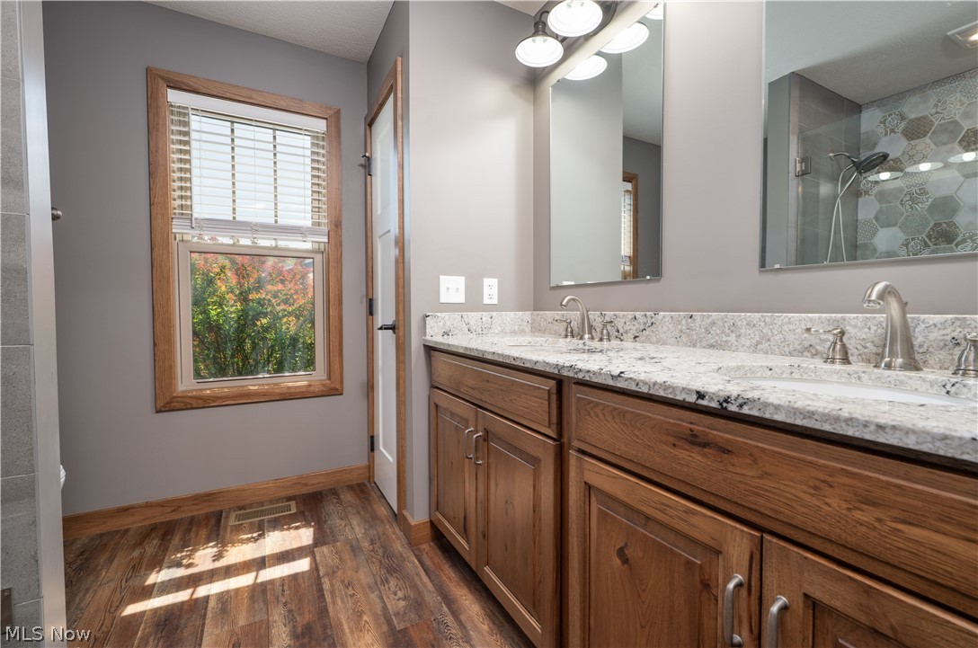 3515 Eastport Road Southeast Dennison, OH 44621 - Photo 19 of 41 Dual vanity with granite countertops, undermount sinks, and brushed nickel fixtures