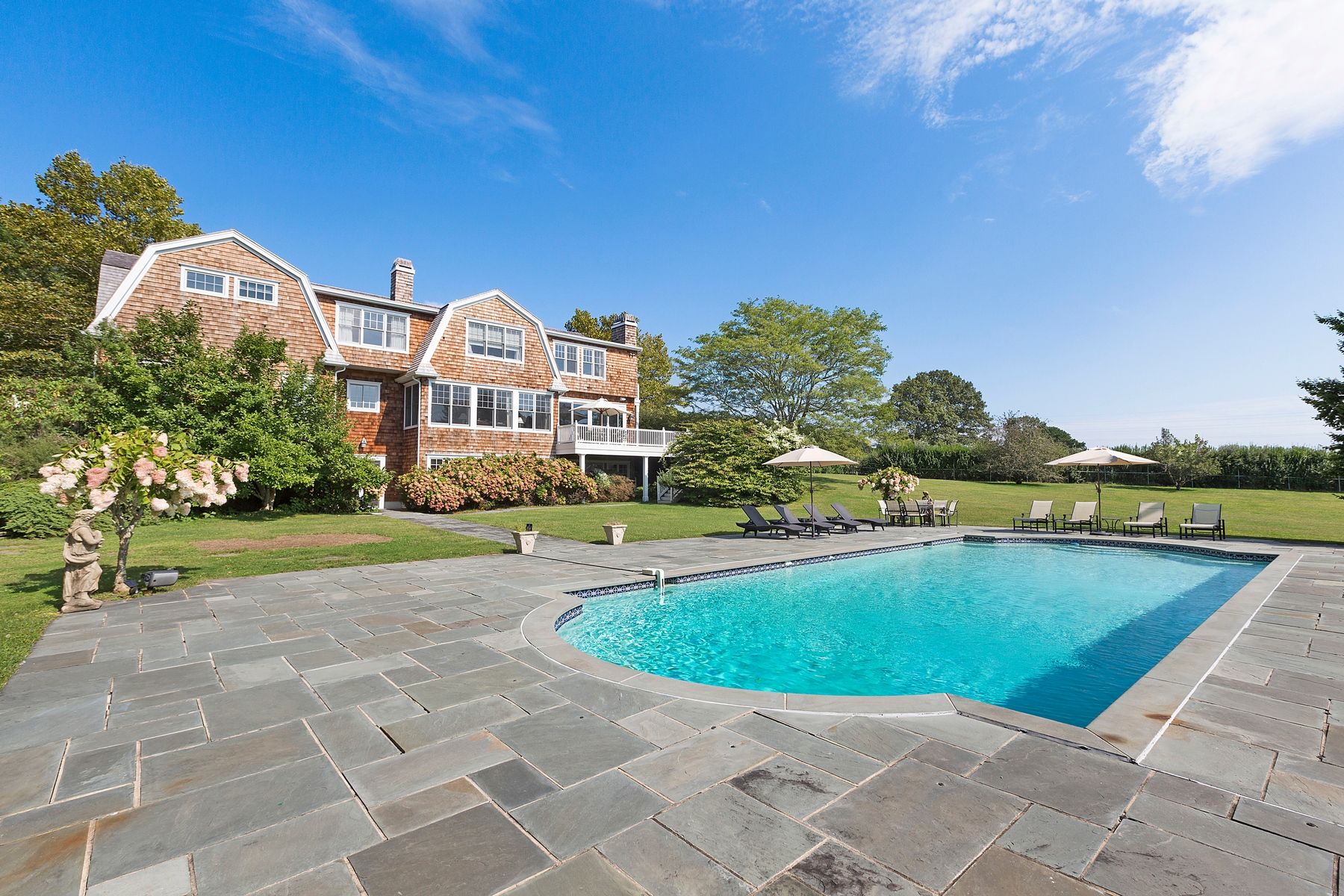 920 Old Sag Harbor Road Water Mill, NY 11976 - Photo 1 of 19 a view of a swimming pool with a yard