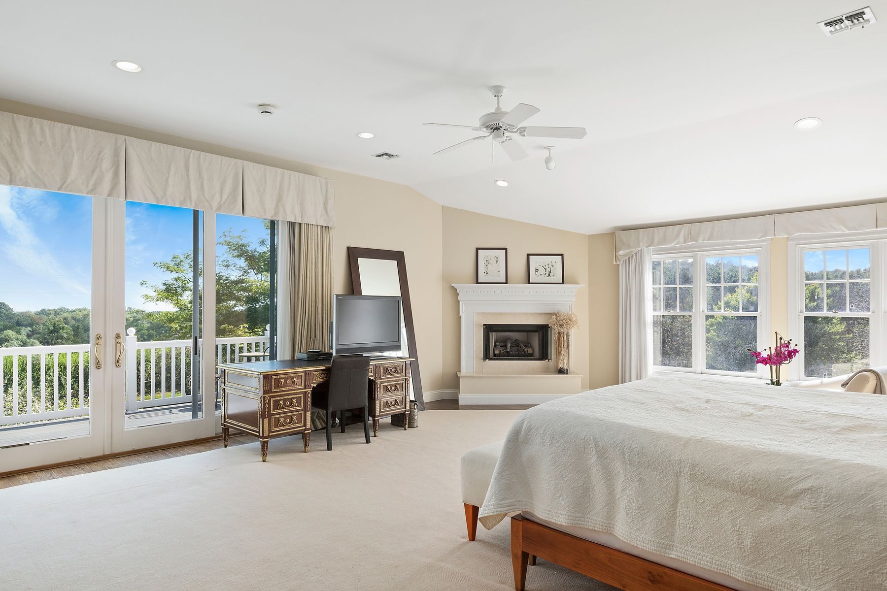 920 Old Sag Harbor Road Water Mill, NY 11976 - Photo 13 of 19 a bedroom with a bed and a chandelier