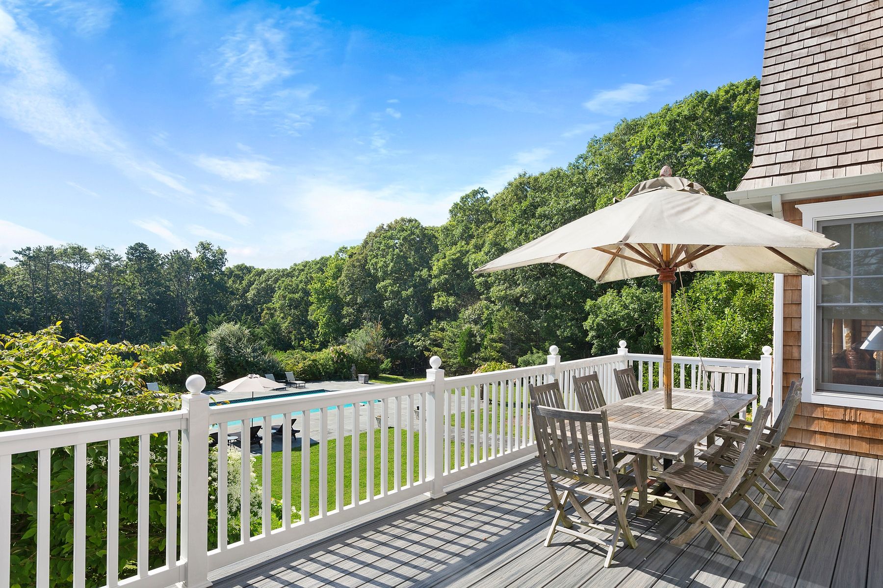920 Old Sag Harbor Road Water Mill, NY 11976 - Photo 6 of 19 a view of a chair and table on the deck