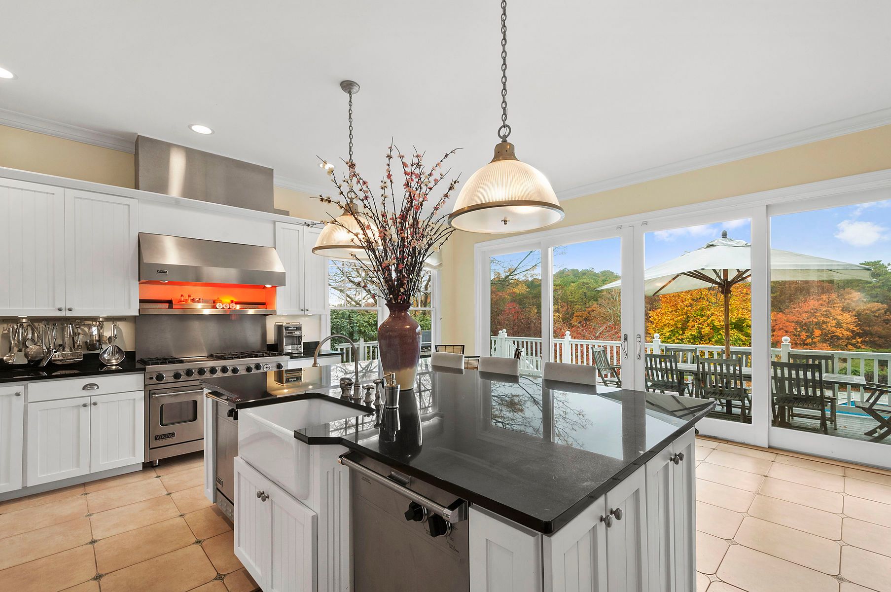 920 Old Sag Harbor Road Water Mill, NY 11976 - Photo 9 of 19 a kitchen with stainless steel appliances granite countertop a sink a stove and a wooden floors