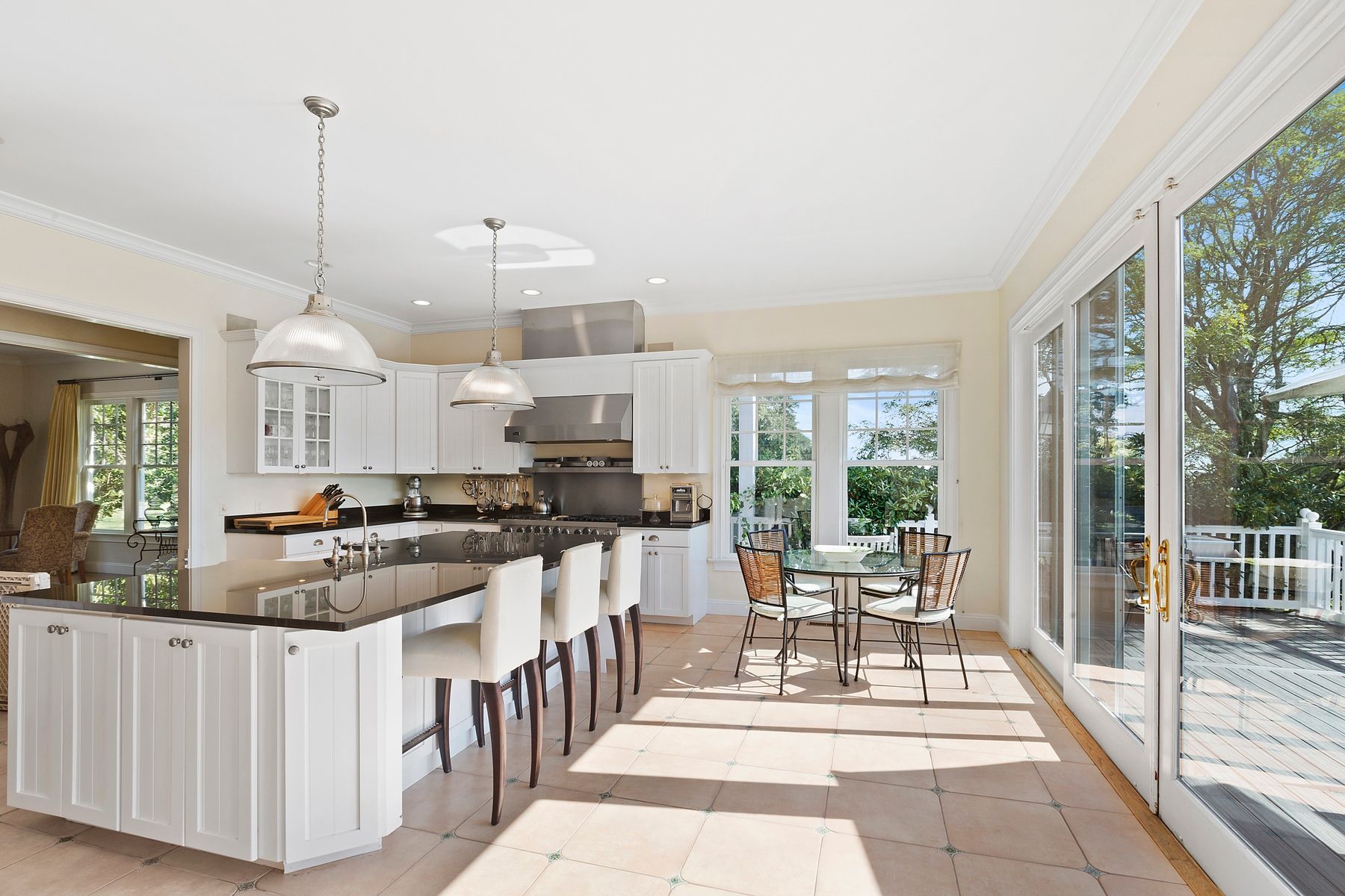 920 Old Sag Harbor Road Water Mill, NY 11976 - Photo 10 of 19 a dining hall with stainless steel appliances granite countertop a stove and cabinets