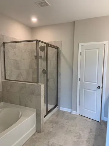 a bathroom with a bathtub and a shower